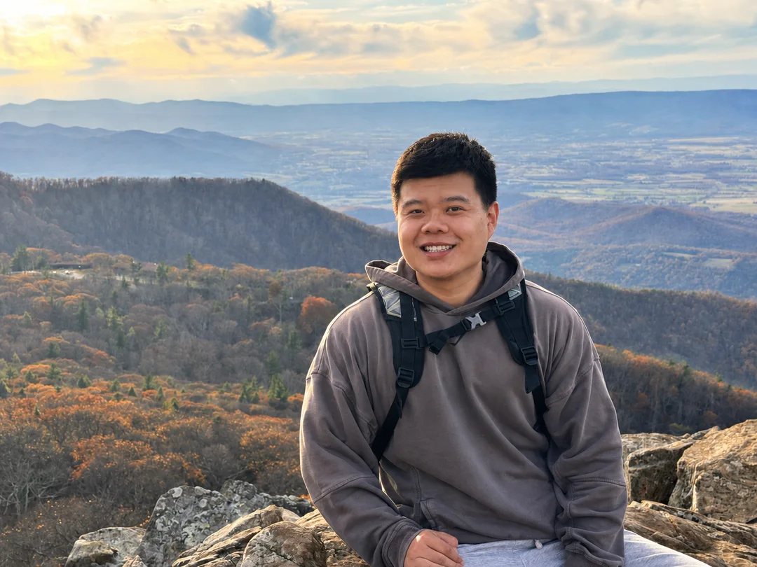 Tianhao Li outdoors against a mountain landscape
